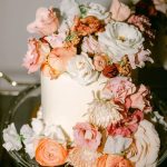 Small cutting cake with coral and white flowers all around