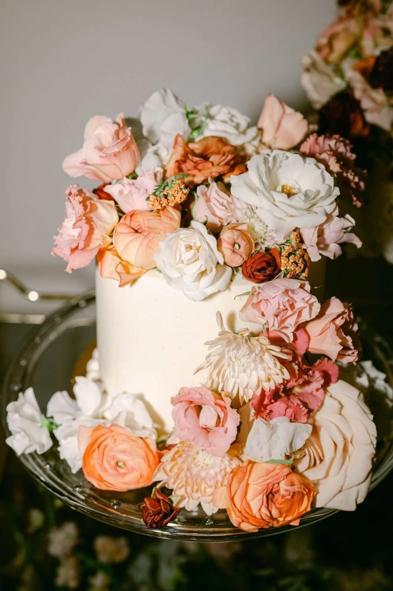 Small cutting cake with coral and white flowers all around