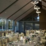 indoor wedding reception with large windows and high ceilings
