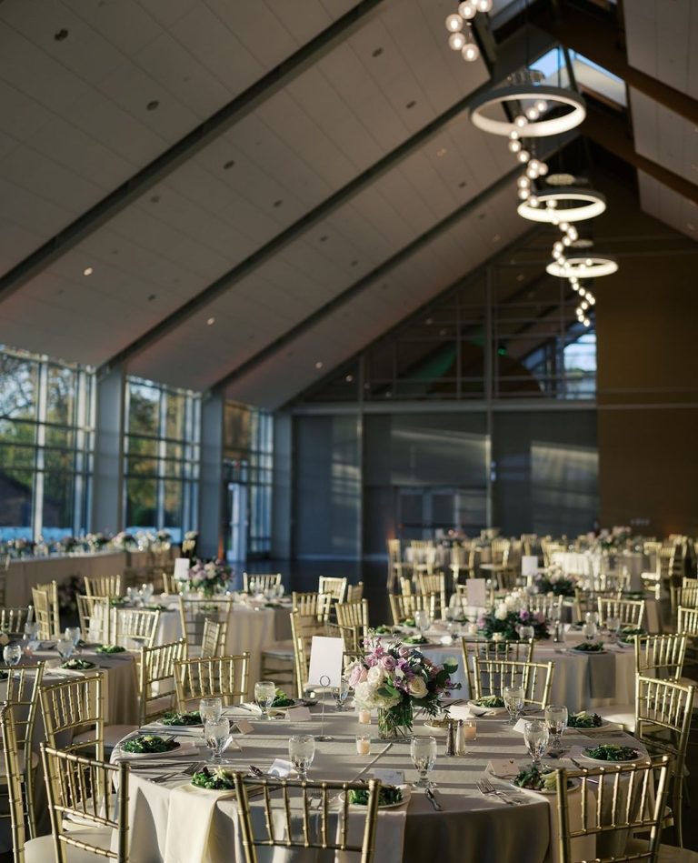 indoor wedding reception with large windows and high ceilings