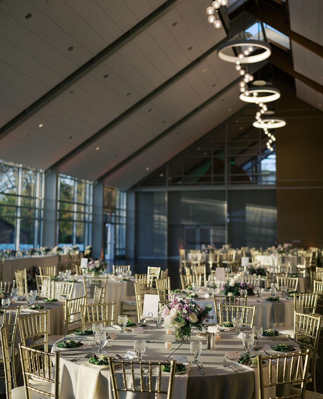 indoor wedding reception with large windows and high ceilings
