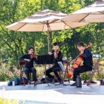 String Trio playing at outdoor wedding ceremony by pool