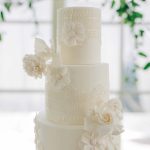 White four tier wedding cake with white flowers