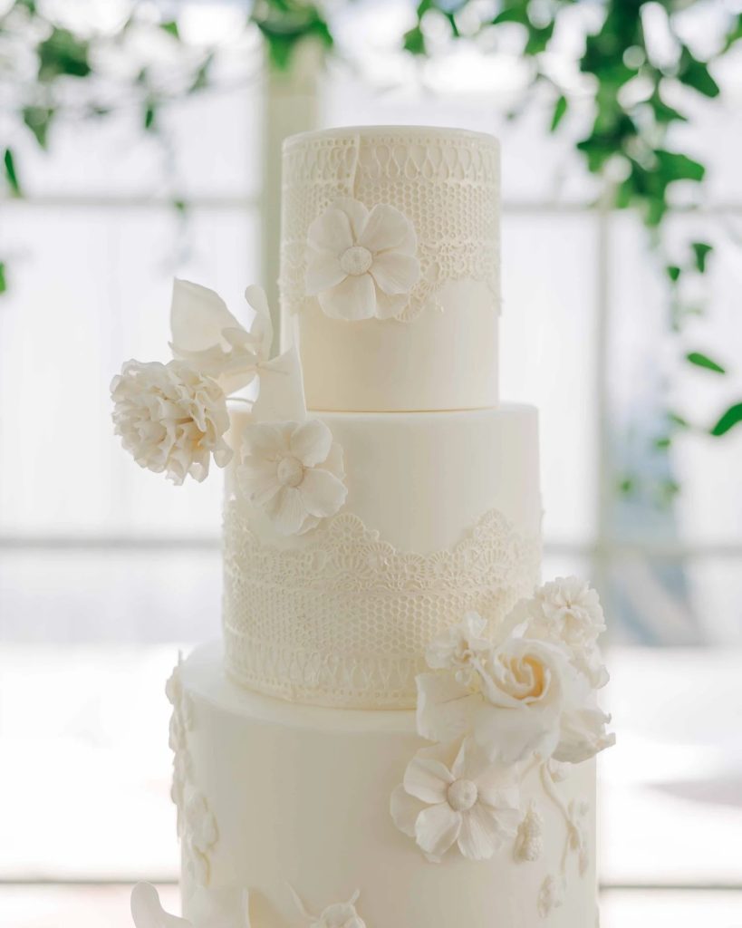 White four tier wedding cake with white flowers