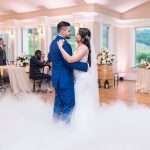 Wedding couple dancing at indoor wedding ceremony at vineyard