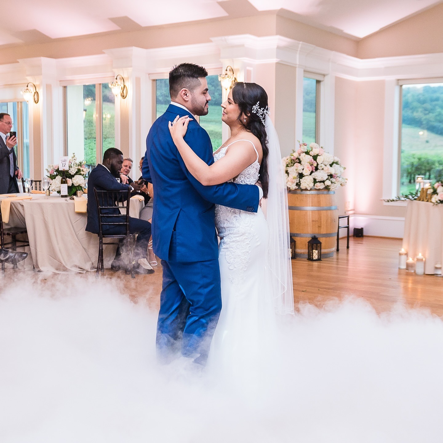Wedding couple dancing at indoor wedding ceremony at vineyard