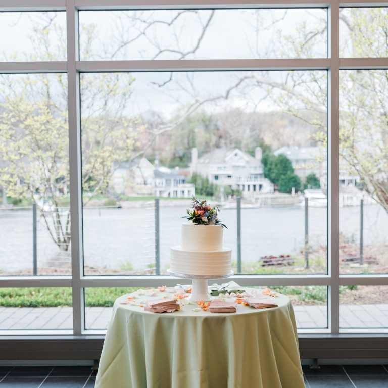 Wedding Cake at indoor wedding reception looking out over waterfront