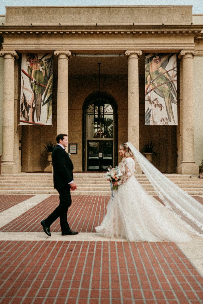 couple walking towards each other in front of wedding venue