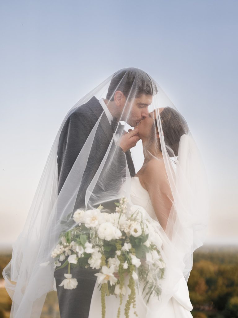 Husband and wife kiss under veil | cinematic wedding photography