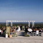 Outdoor ceremony space with large white pergola overlooking scenic mountains
