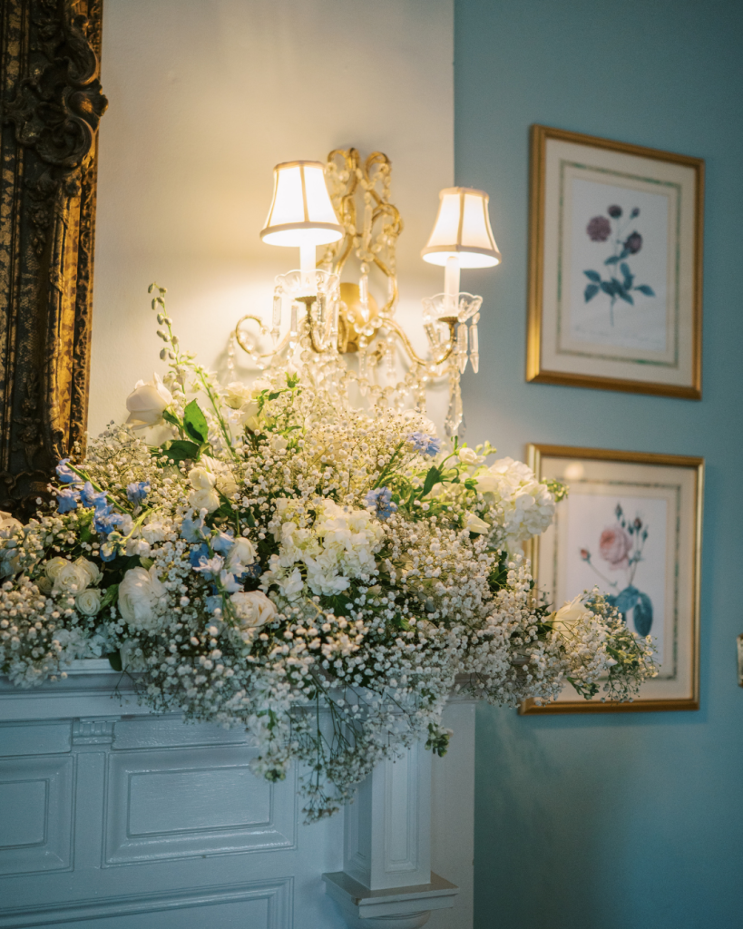 Floral installation with blue and white blooms on wall sconce at The Morehead Inn Charlotte by Flowers of Charlotte