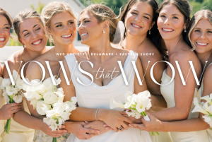 Bride with bridesmaids in butter yellow dresses holding white bouquets during coastal Delaware wedding at Bayside Resort Golf Club.
