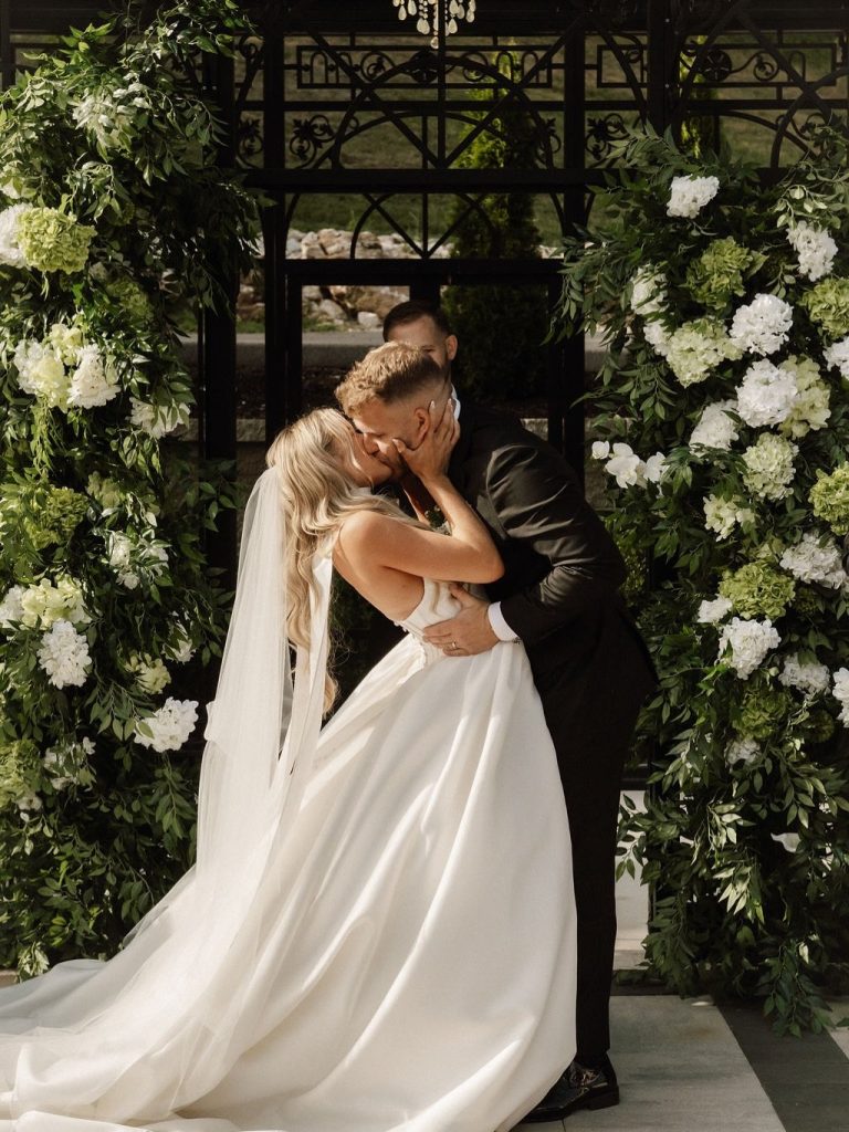 Bride and groom first kiss at an outdoor ceremony at Knotting Hills. Photo by Desert Luna.