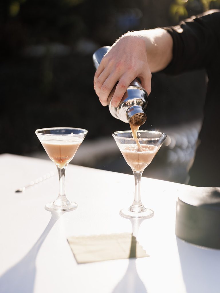 Bar creating espresso martinis at wedding cocktail hour