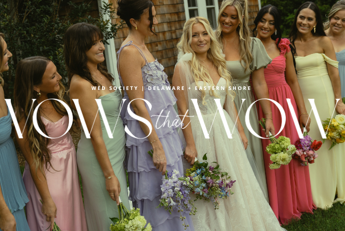 Bride with bridesmaids in colorful dresses outside cottage at coastal Delaware garden wedding in Ocean View