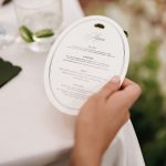 Hand holding oval reception menu