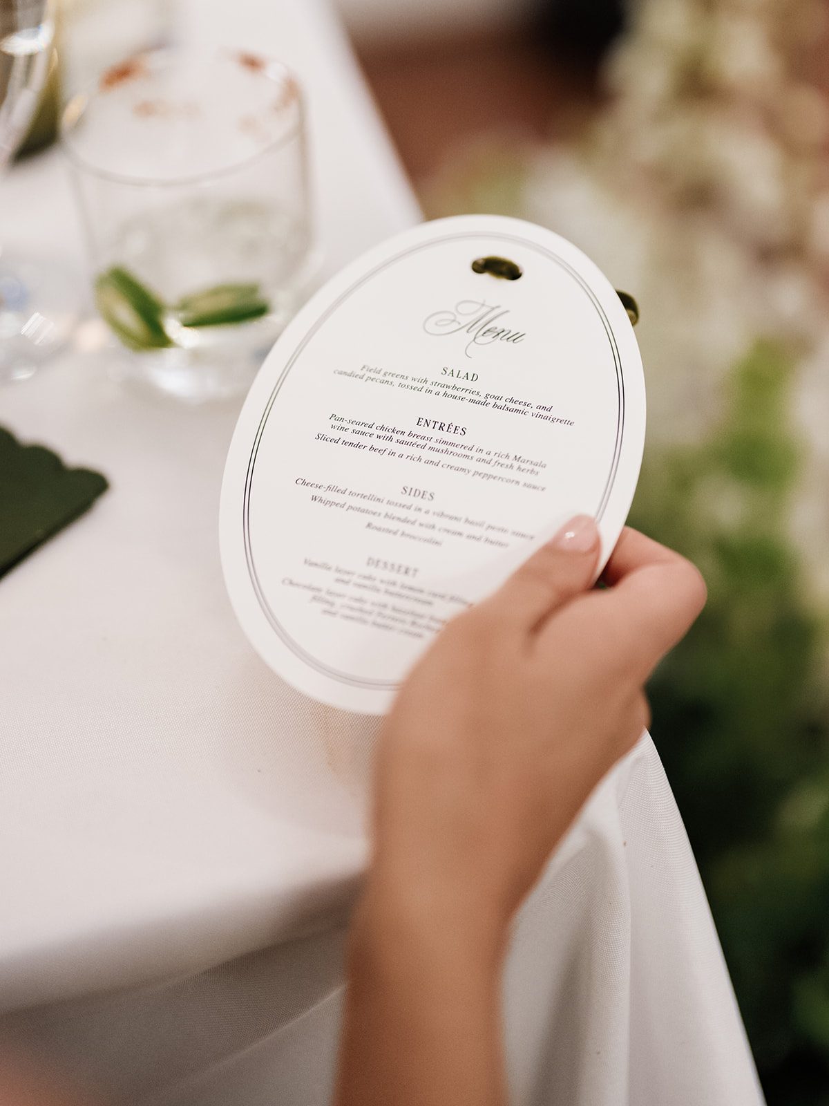 Hand holding oval reception menu