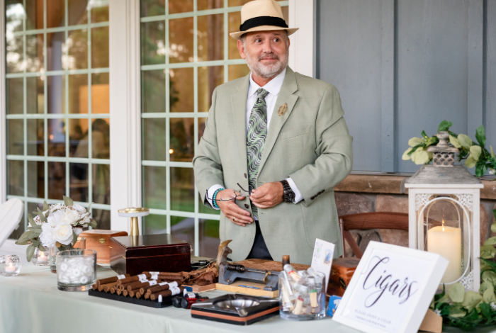 Cigar rolling station by Blue Hen Torcedor set up at a wedding, featuring premium cigars and tools for a live guest experience.