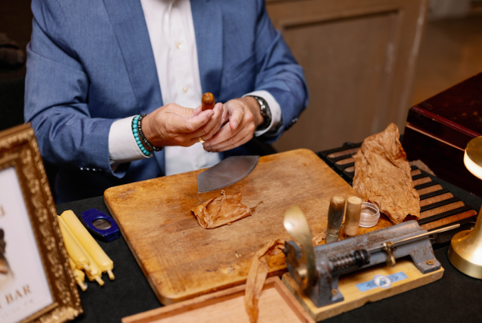 Close-up of a cigar being hand-rolled by Blue Hen Torcedor during an interactive wedding cigar bar experience.