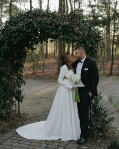 Bride and groom under ivy arch at Morning Glory Farms NC
