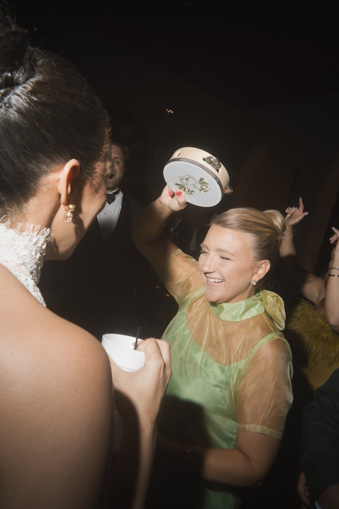 Bridesmaid on the dance floor with a custom tambourine by Fête Society.