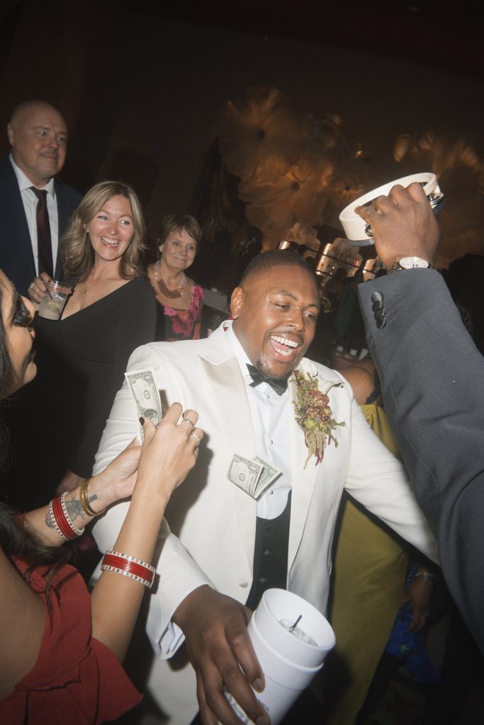 Groom dancing in a white tuxedo. Music by Spin Society DJs.
