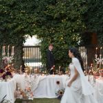 blurred photo of bride and groom walking through outdoor reception
