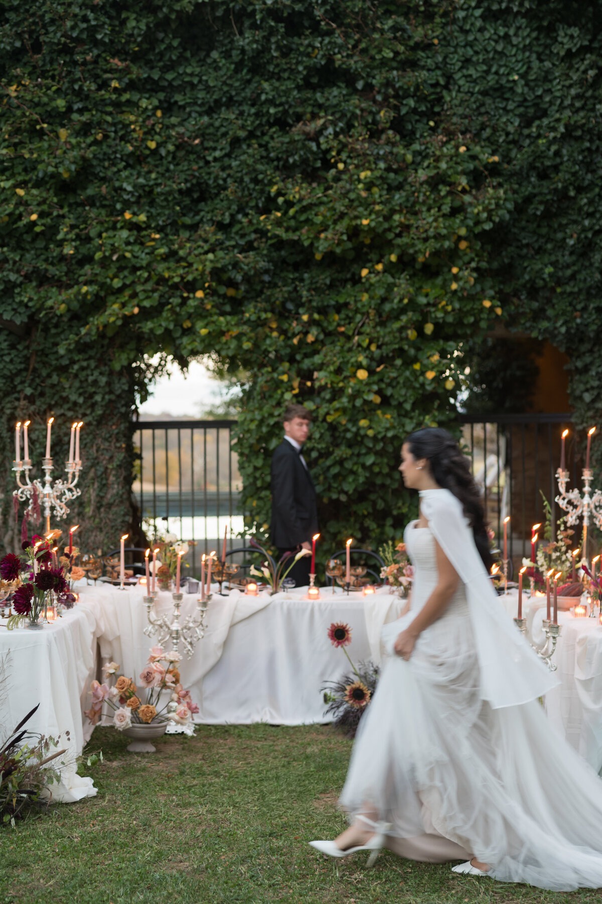 blurred photo of bride and groom walking through outdoor reception