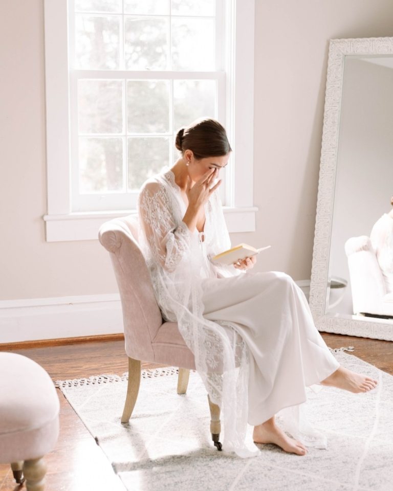 Bride reading letter from groom before wedding