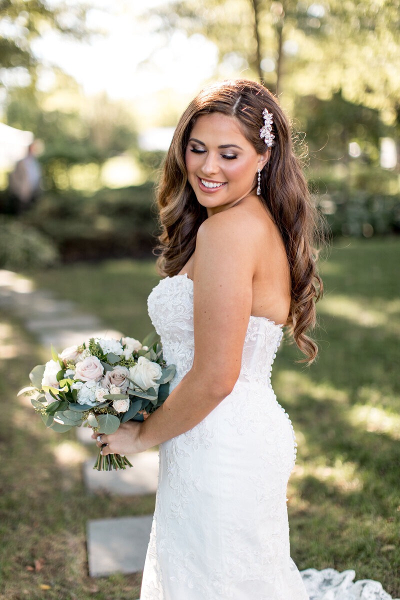 bride posing with old hollywood style hair pinned with ornate hairpain