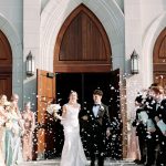 bride and groom walking out of church with confetti getting tossed