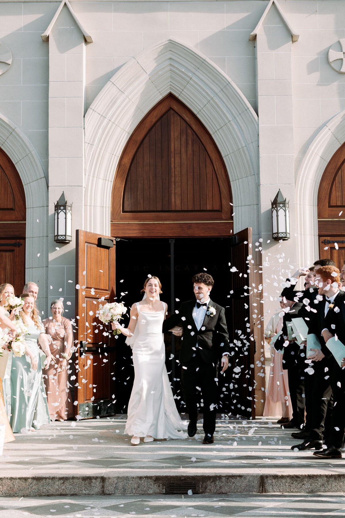 bride and groom walking out of church with confetti getting tossed