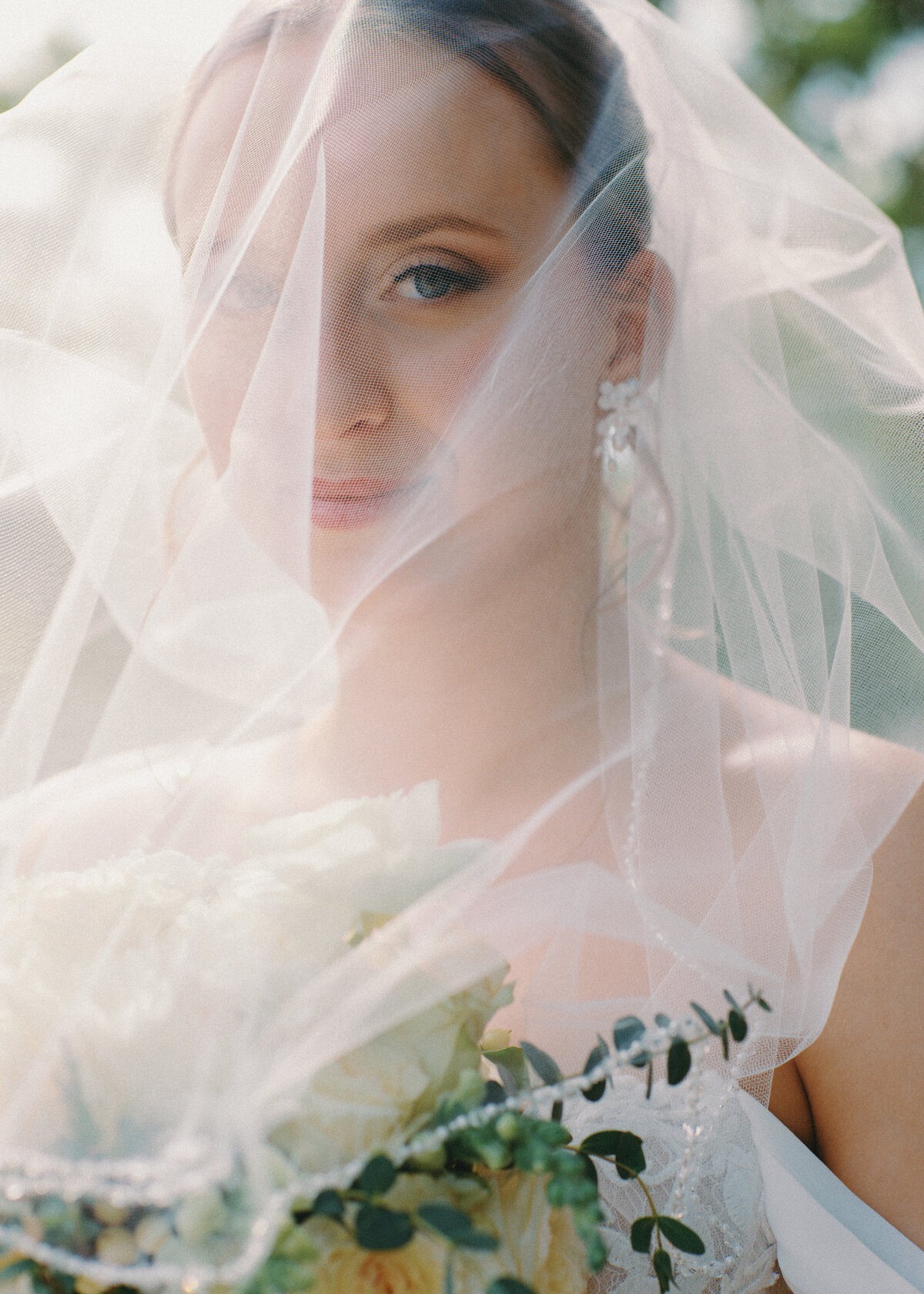 bride with veil over face portrait