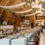 wedding reception with neutral decor in barn