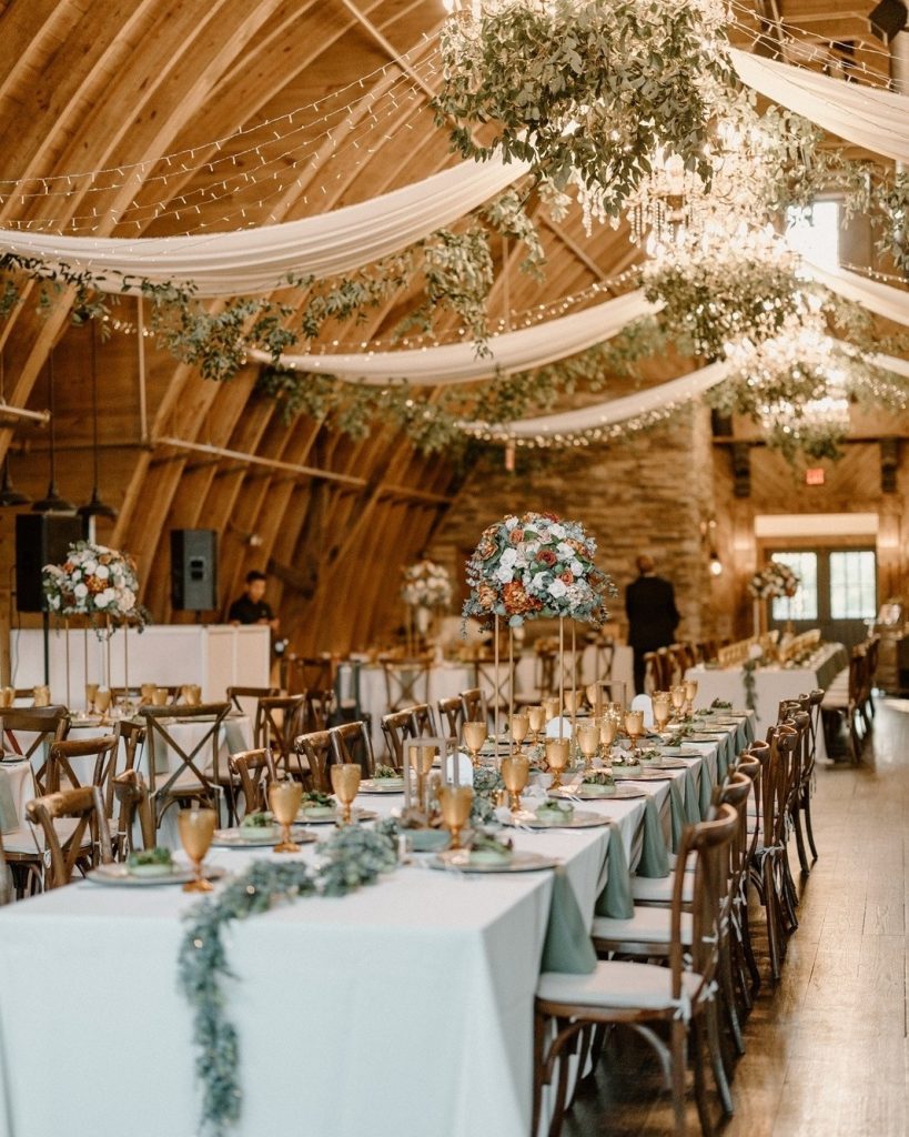 wedding reception with neutral decor in barn