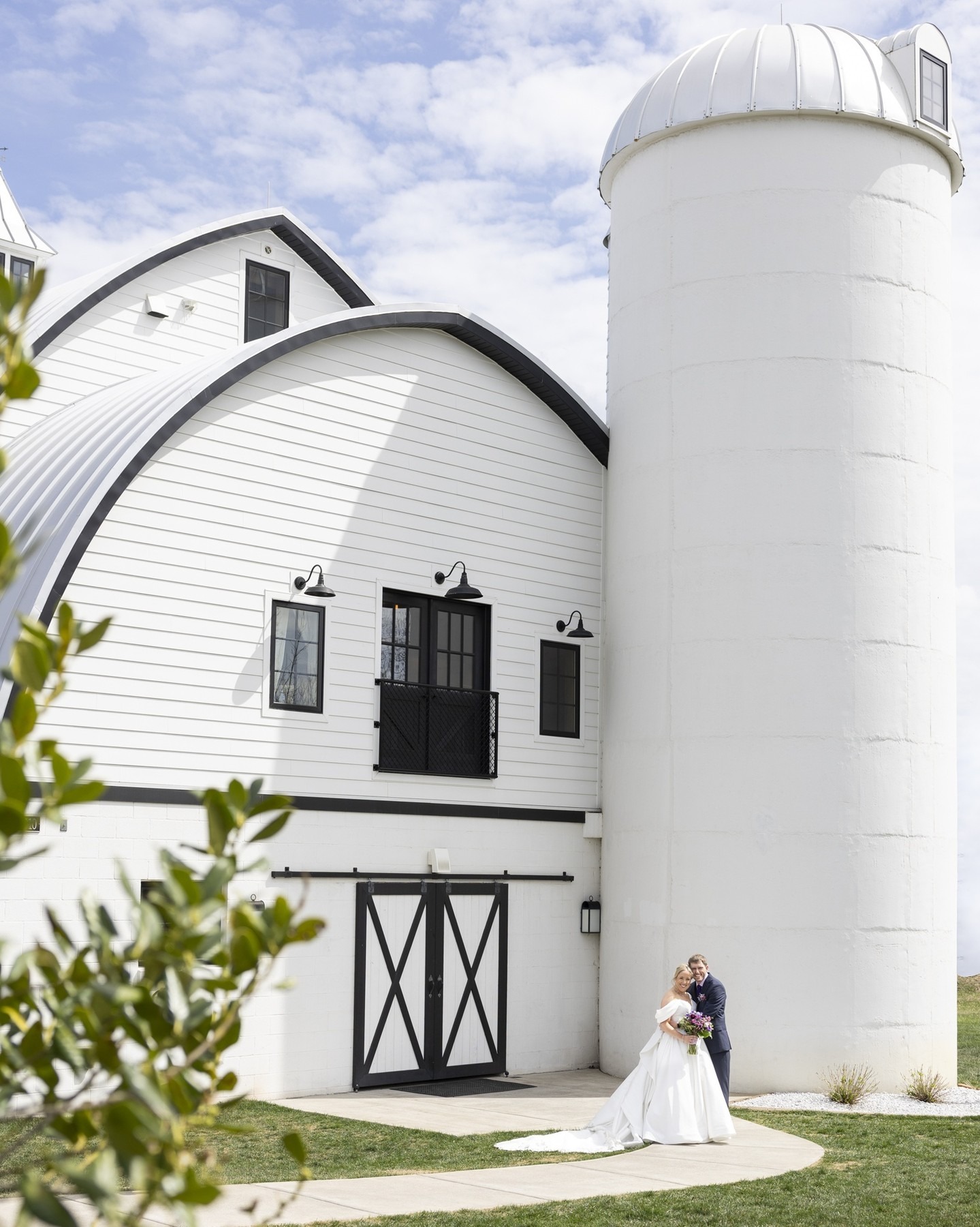 Bride and Groom posing outside of wedding barn in northern virginia