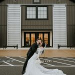 Bride and groom kissing in front of wedding reception space