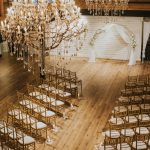 indoor wedding reception with wood floors and high ceilings