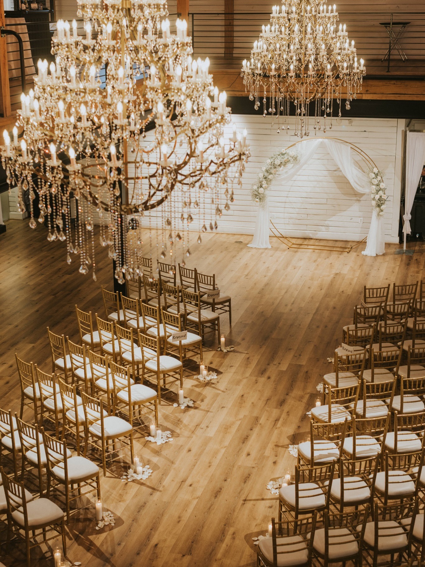 indoor wedding reception with wood floors and high ceilings