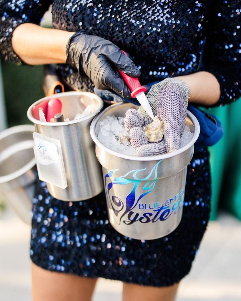 close-up of a female shucking oysters at a wedding in columbus