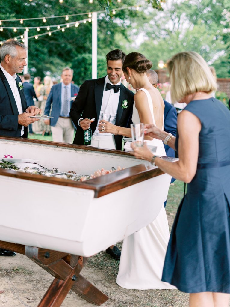 Bride and Groom with guests around a table with drinks