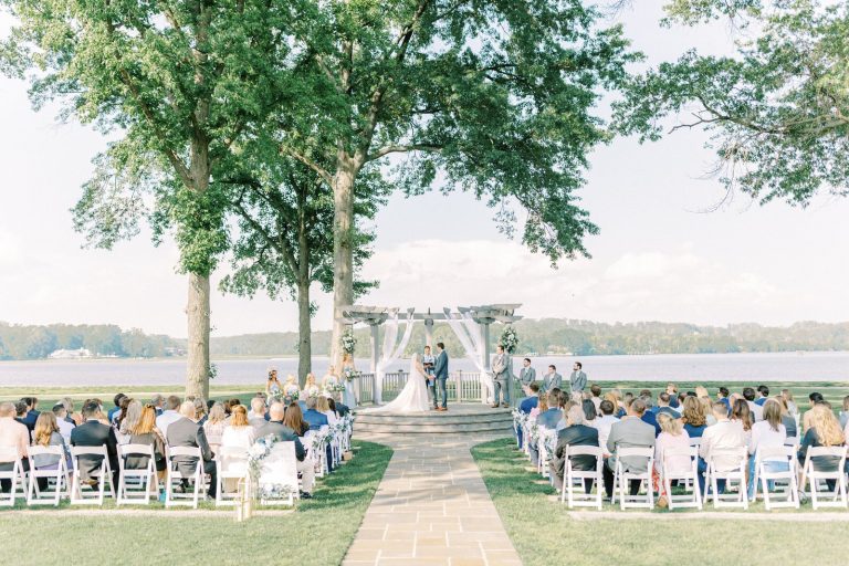 couple getting married at outdoor wedding ceremony golf course