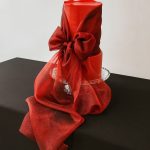 Red wedding cake with red sheer ribbon