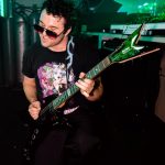 dj playing electric guitar in club