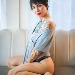 boudoir photo of a women with tattoos and baggy tshirt