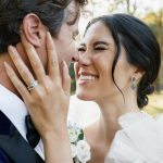 bride holding grooms face with excitement