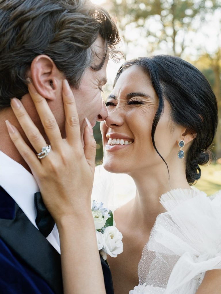 bride holding grooms face with excitement