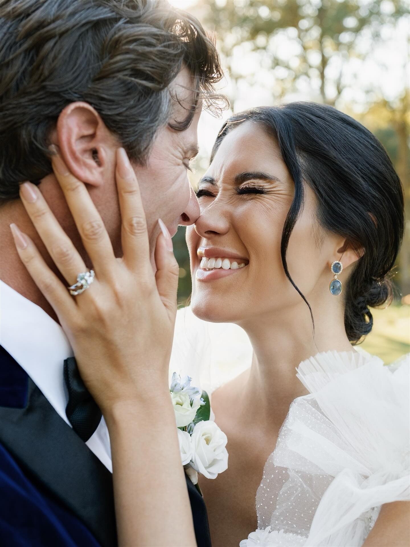 bride holding grooms face with excitement