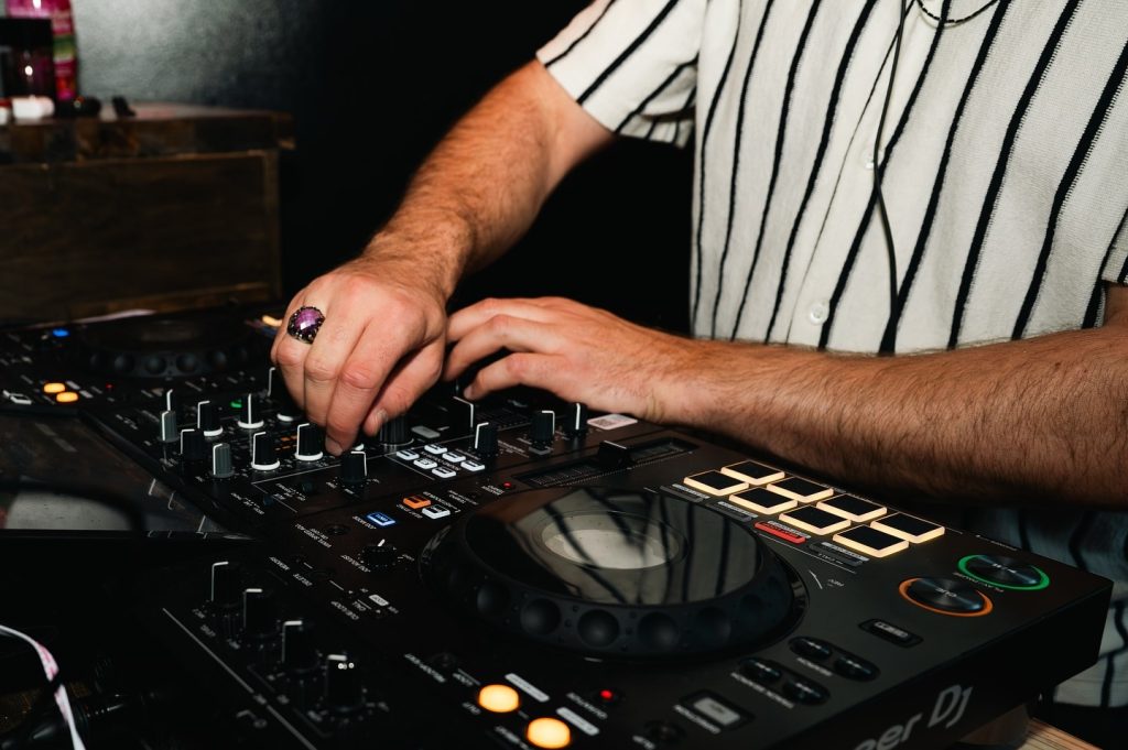 close up of dj hands spinning the dj board