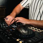 close up of dj hands spinning the dj board